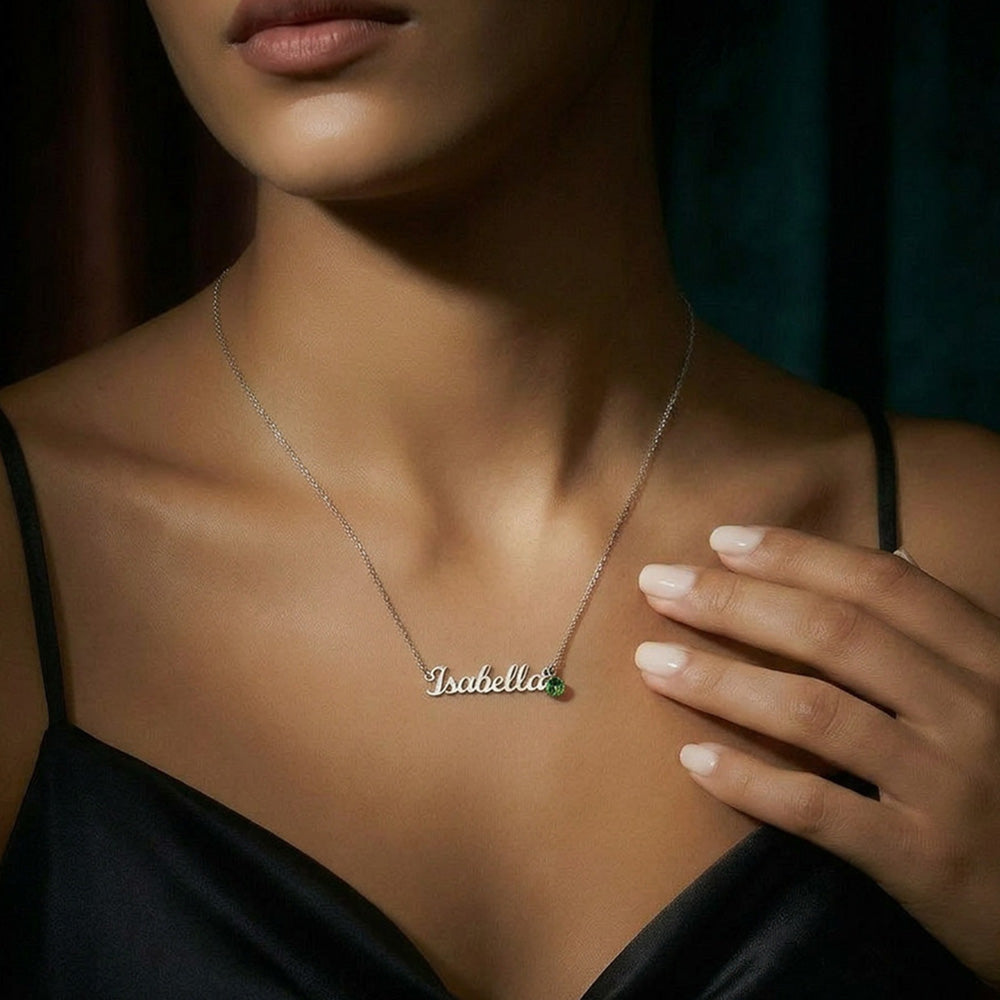 Woman wearing a delicate silver-tone necklace with the sample name Isabella.