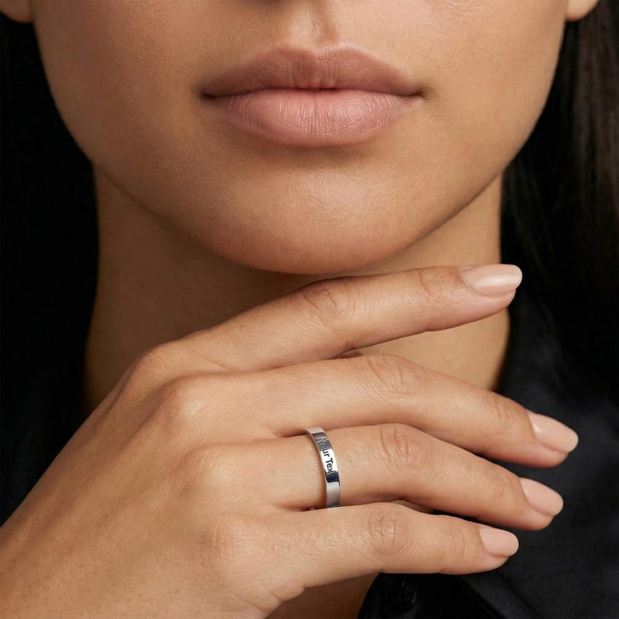 Close-up of a woman wearing the polished ring, with the sample engraving 'Your Text' visible.