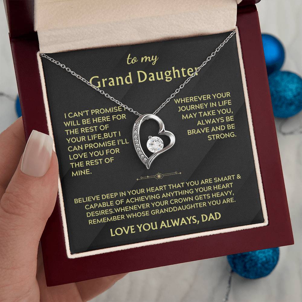 Silver heart necklace in an open red box with the Grand Daughter message card visible