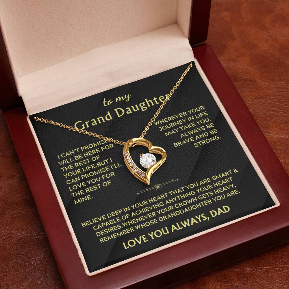 Gold heart pendant necklace displayed in an open red box with a Grand Daughter message card