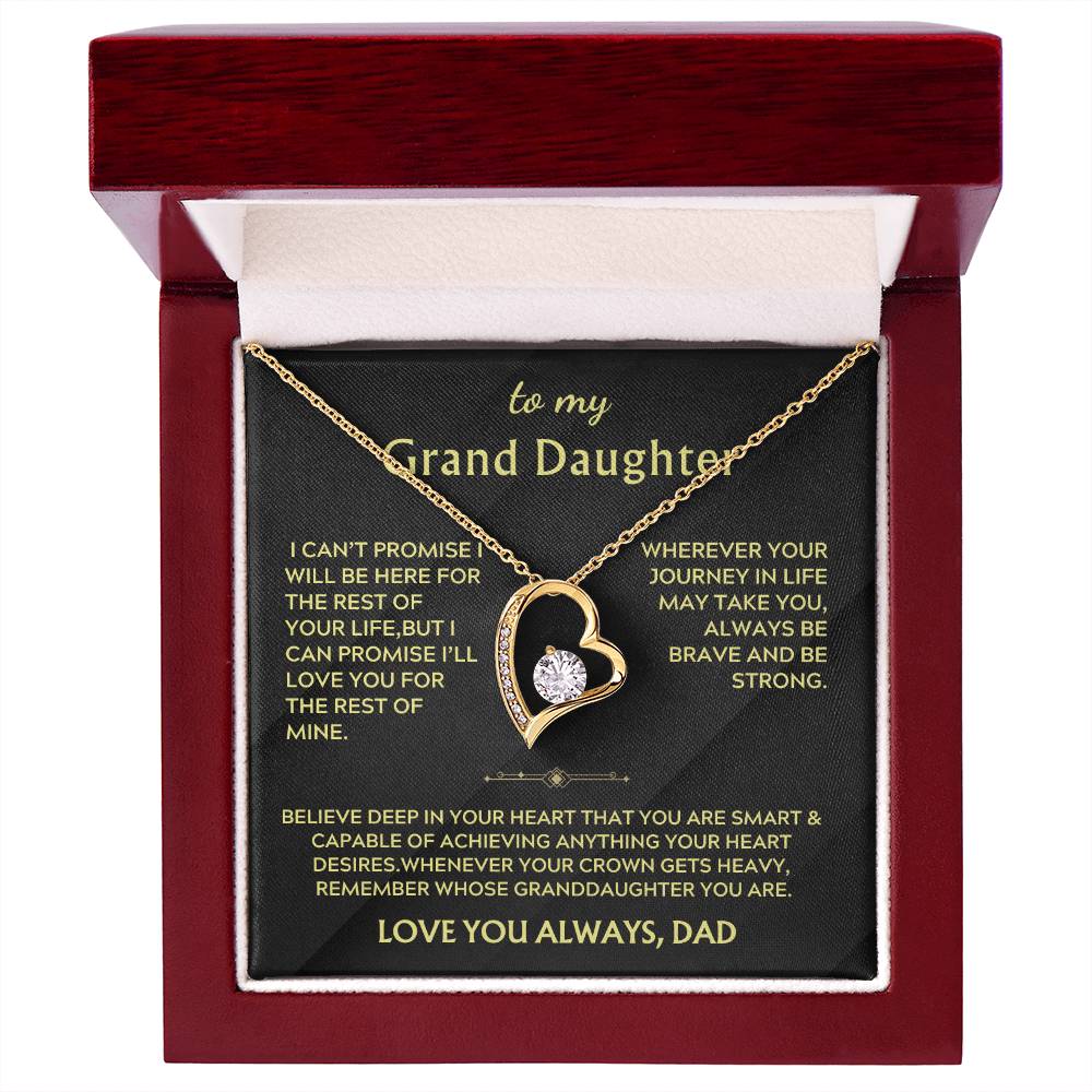 Gold heart necklace in an open red presentation box with a Grand Daughter message card