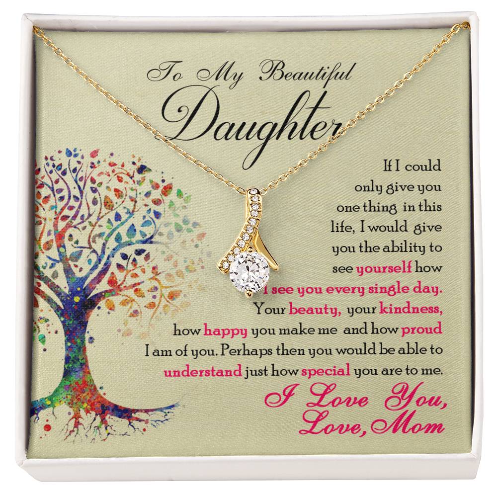Gold-tone ribbon pendant necklace displayed over the daughter message card with a colourful tree.