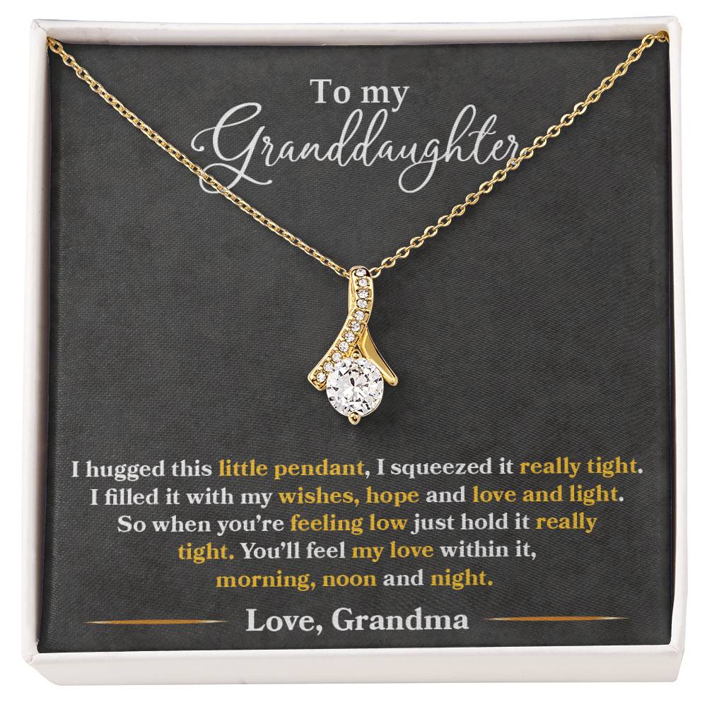 Gold pendant necklace displayed on a granddaughter message card