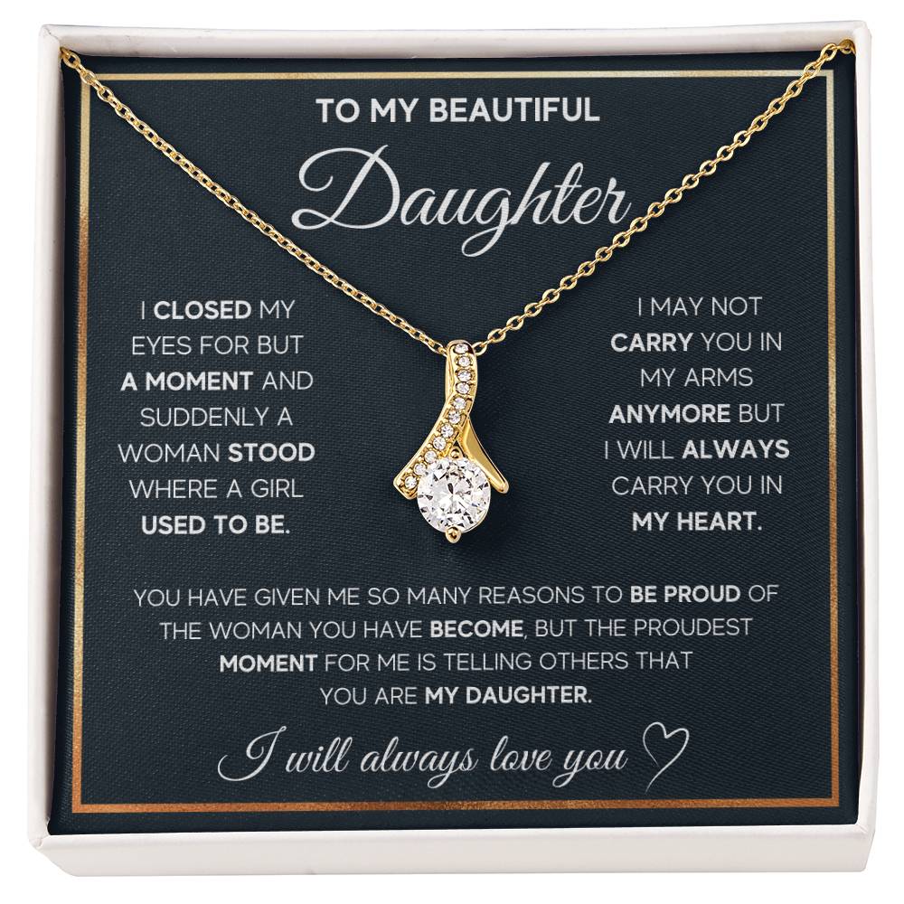 Gold-tone ribbon pendant necklace displayed over a daughter message card in a white presentation box