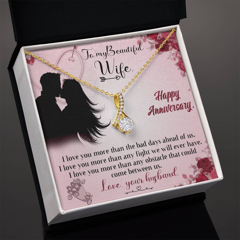 Gold-tone ribbon pendant necklace presented in an open white-edged gift box with an anniversary card.