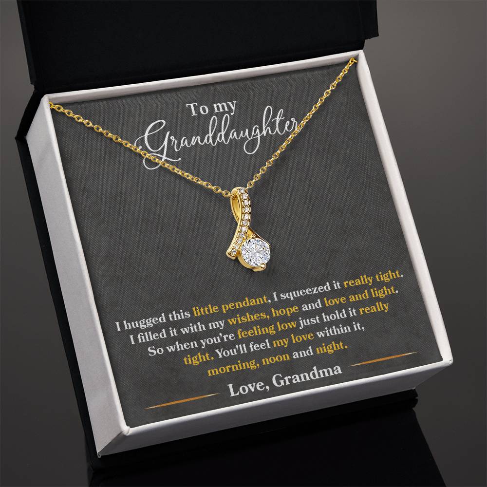 Gold granddaughter message necklace shown in an open presentation box