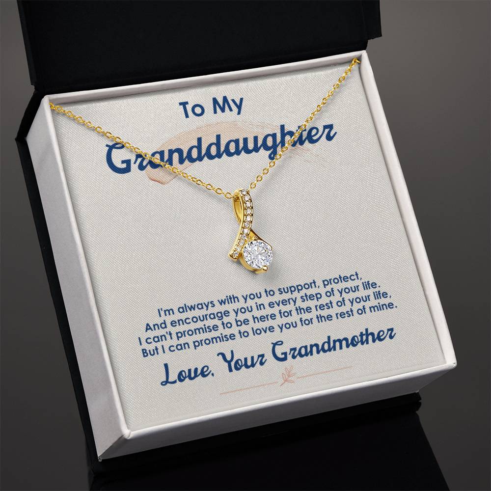 Gold-tone pendant necklace presented in an open black jewellery box with a message card.