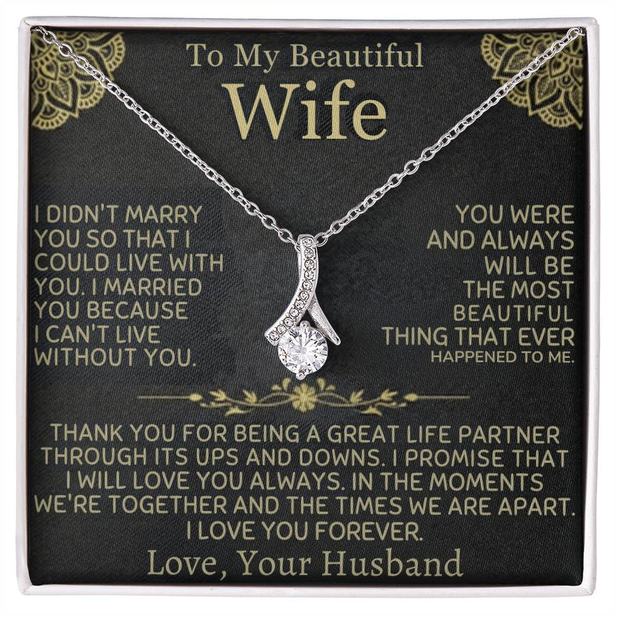 Silver-tone ribbon pendant necklace displayed on a black message card for a wife.
