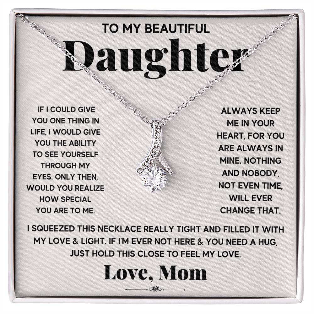 Silver ribbon pendant necklace displayed on a printed message card for a daughter