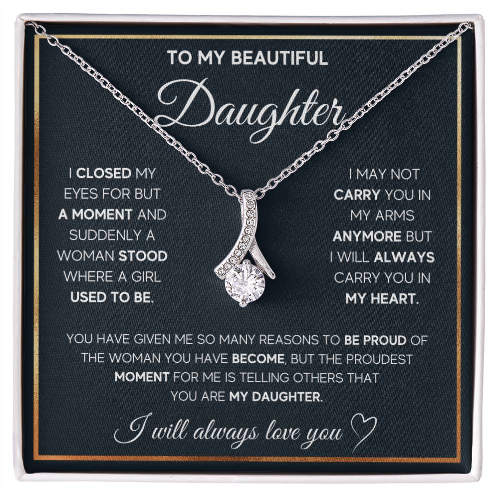 Silver ribbon pendant necklace displayed over a daughter message card in a white presentation box