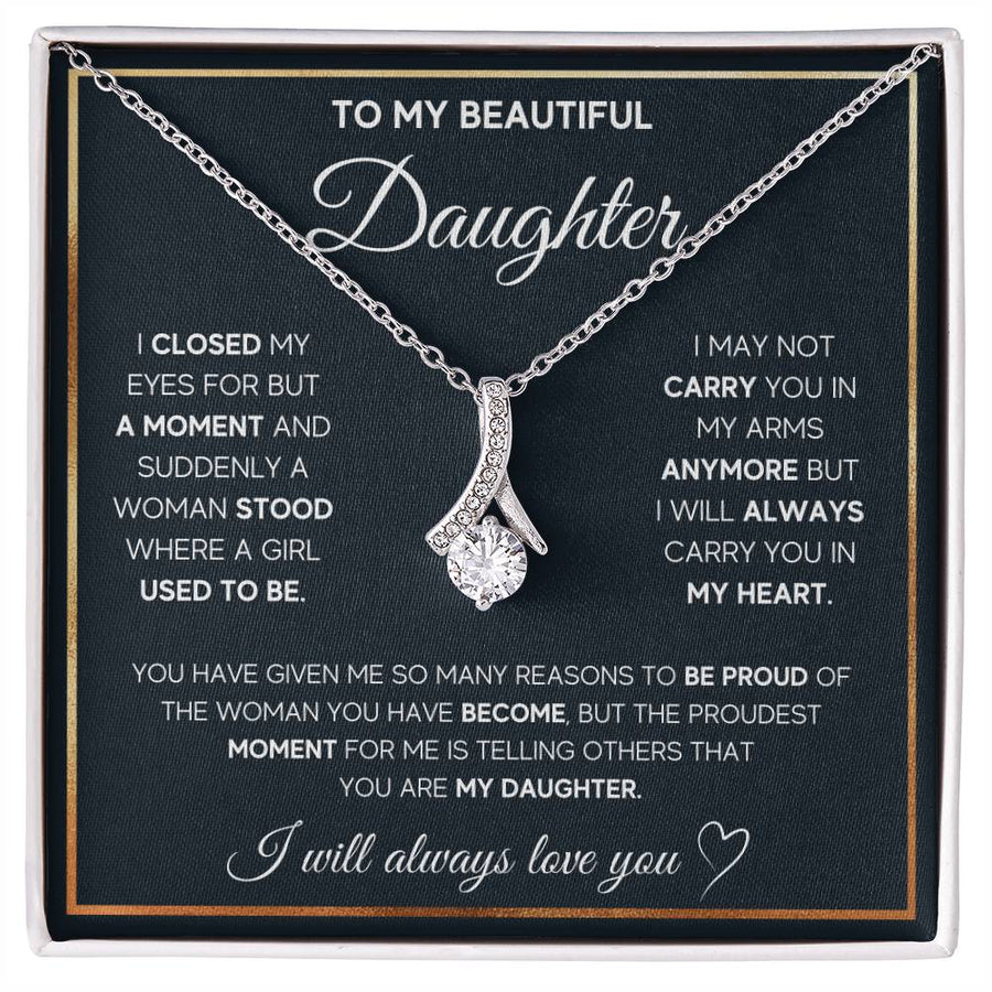 Silver ribbon pendant necklace displayed over a daughter message card in a white presentation box