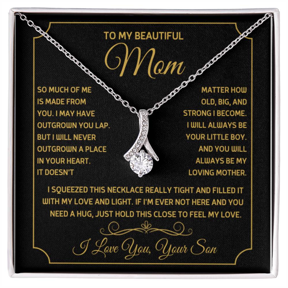 Silver ribbon pendant necklace on a black message card in a white presentation box