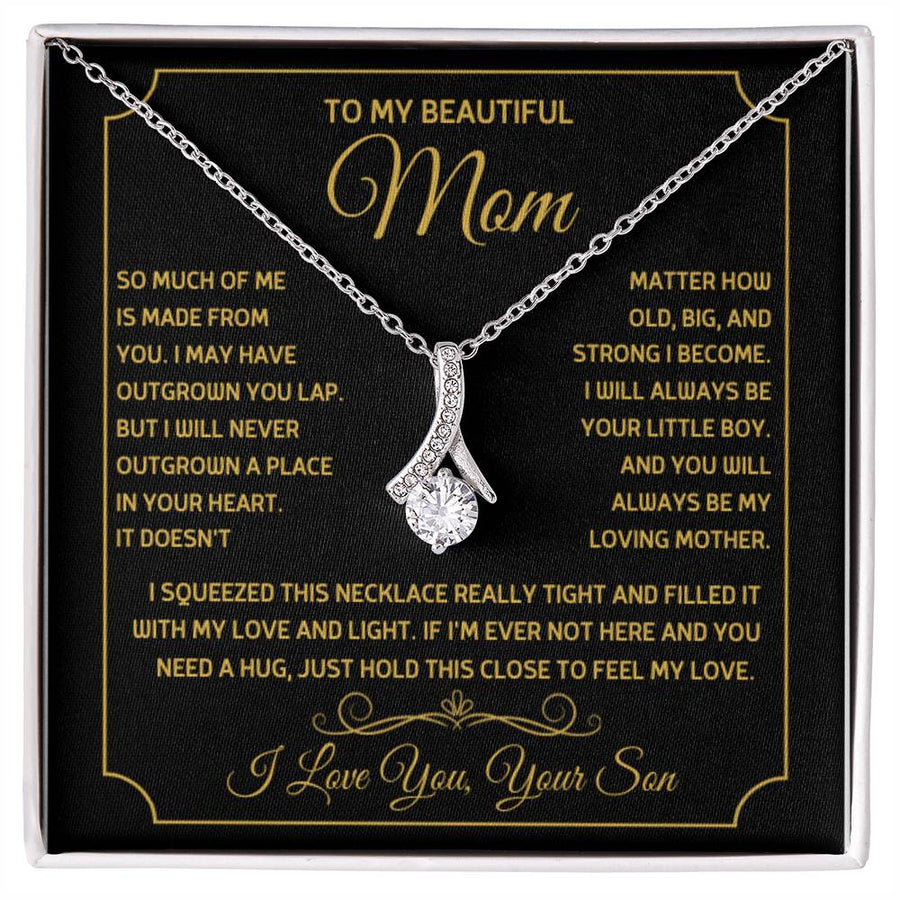 Silver ribbon pendant necklace on a black message card in a white presentation box