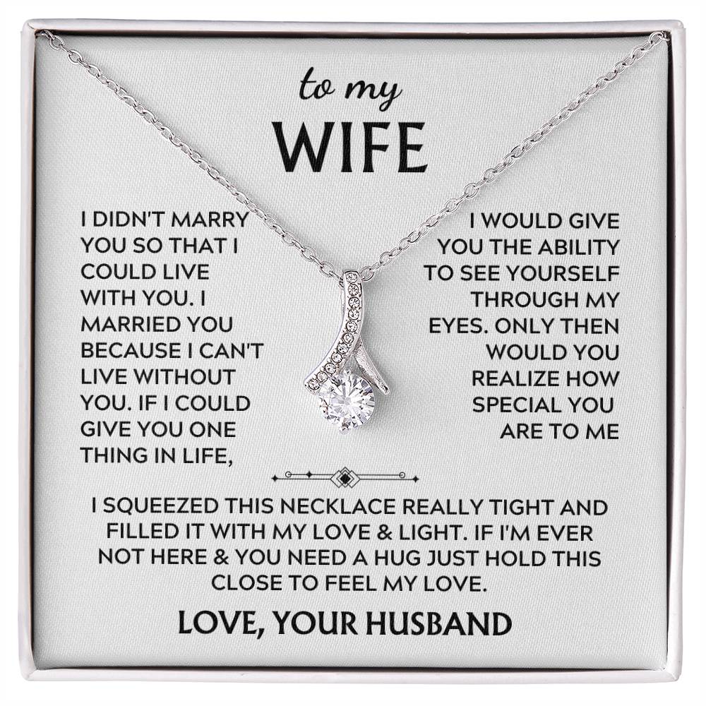 Silver-tone ribbon pendant necklace displayed on a printed wife message card.