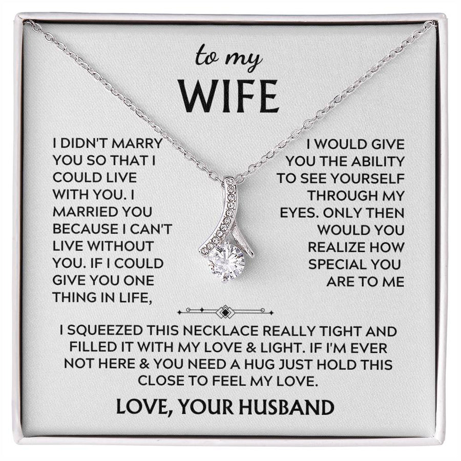 Silver-tone ribbon pendant necklace displayed on a printed wife message card.