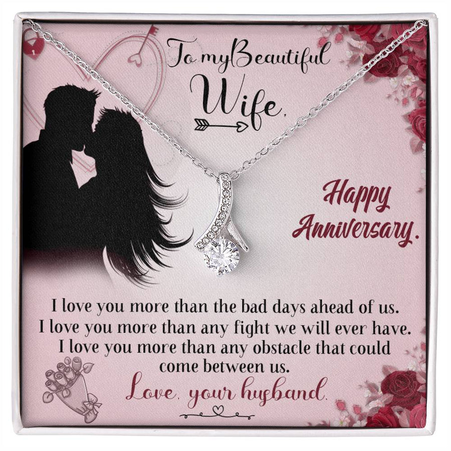 Silver-tone ribbon pendant necklace displayed on a pink anniversary message card for a wife.