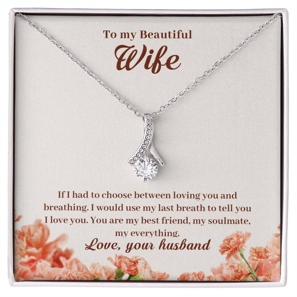 Silver-tone ribbon pendant necklace displayed on a floral message card addressed to a beautiful wife.