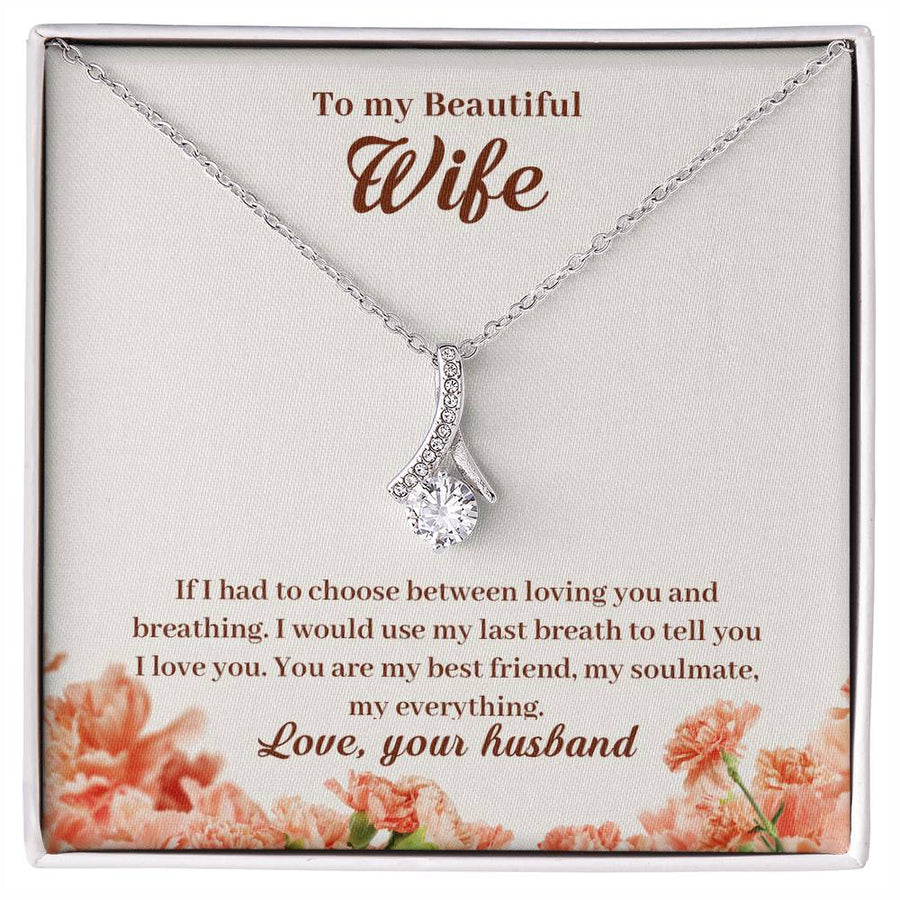 Silver-tone ribbon pendant necklace displayed on a floral message card addressed to a beautiful wife.