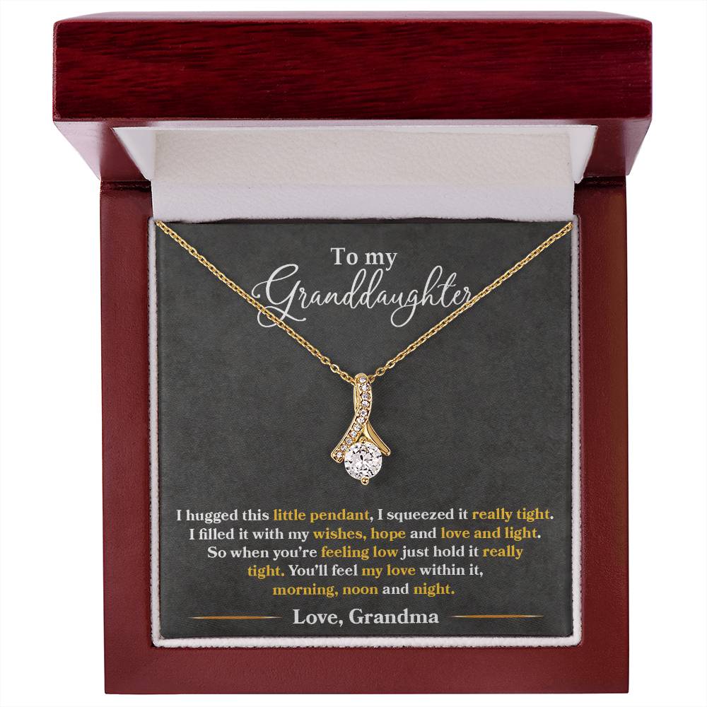 Gold pendant necklace and granddaughter message card in a mahogany box