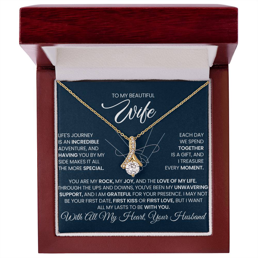 Red wooden-style gift box displaying a gold-tone necklace and wife message card