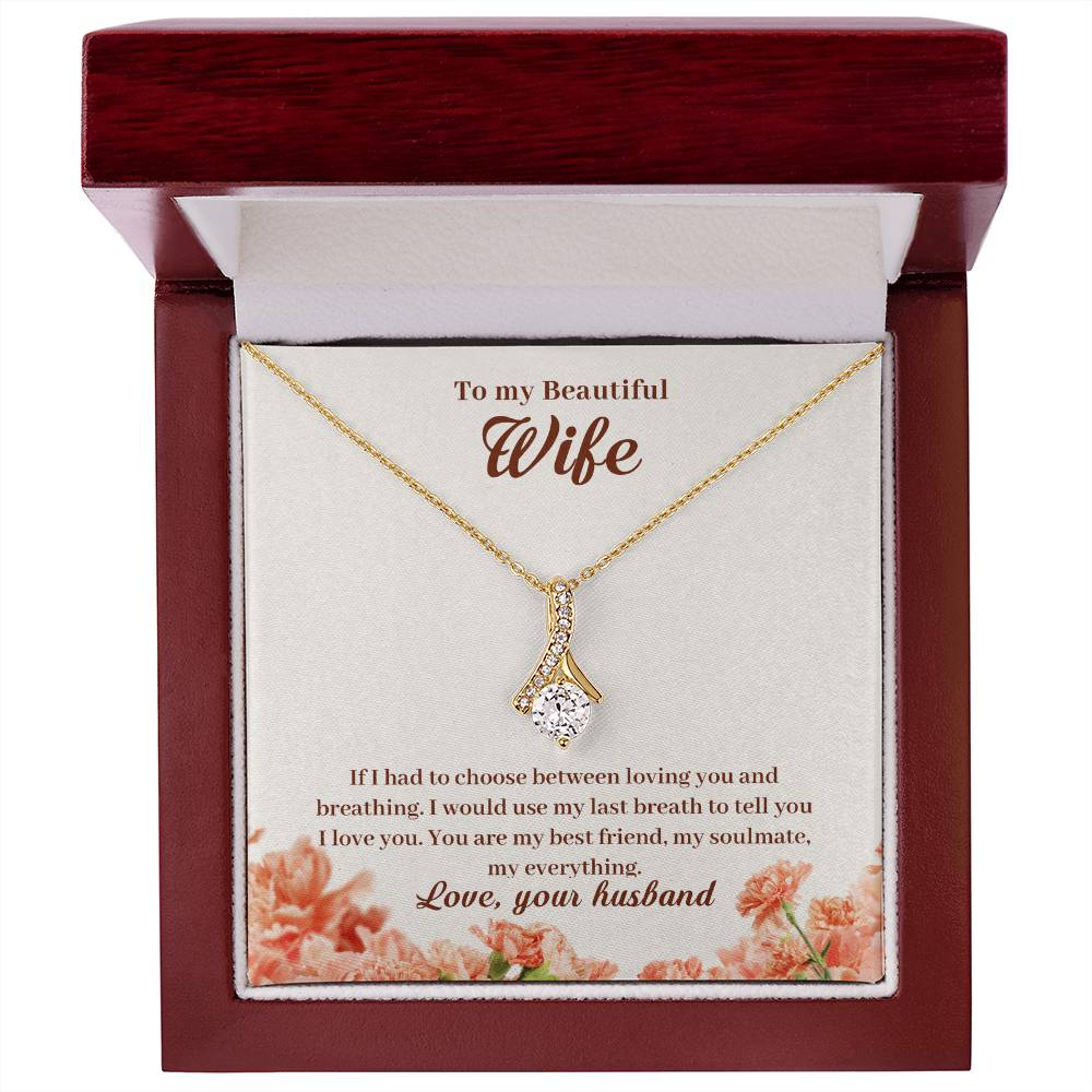 Mahogany jewellery box displaying a gold-tone pendant and message card for a wife.