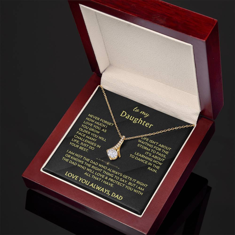 Open red jewellery box with gold ribbon pendant and printed daughter message card