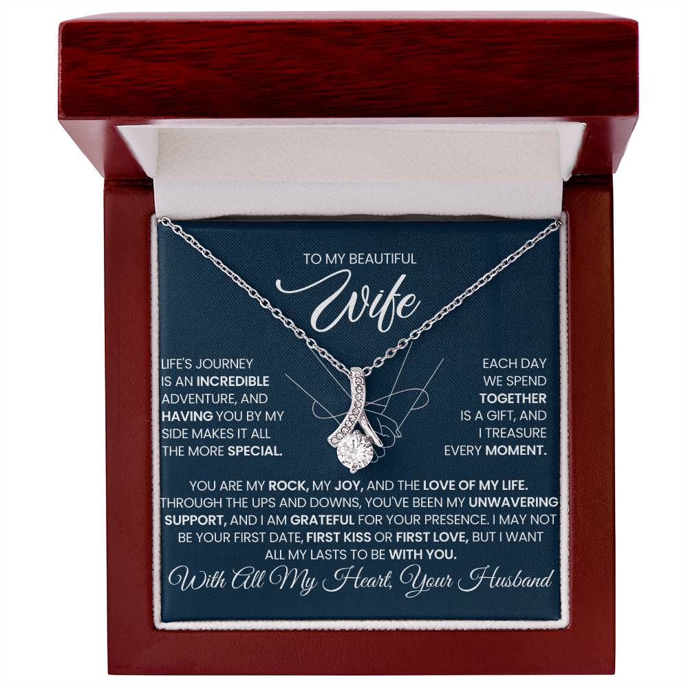 Red wooden-style gift box displaying a silver-tone necklace and wife message card