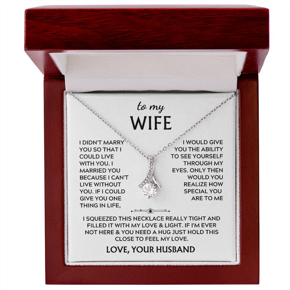 Silver-tone ribbon pendant necklace and wife message card in an open mahogany-coloured box.