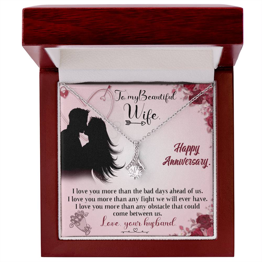Silver-tone ribbon pendant necklace and anniversary card displayed inside an open mahogany-style box.