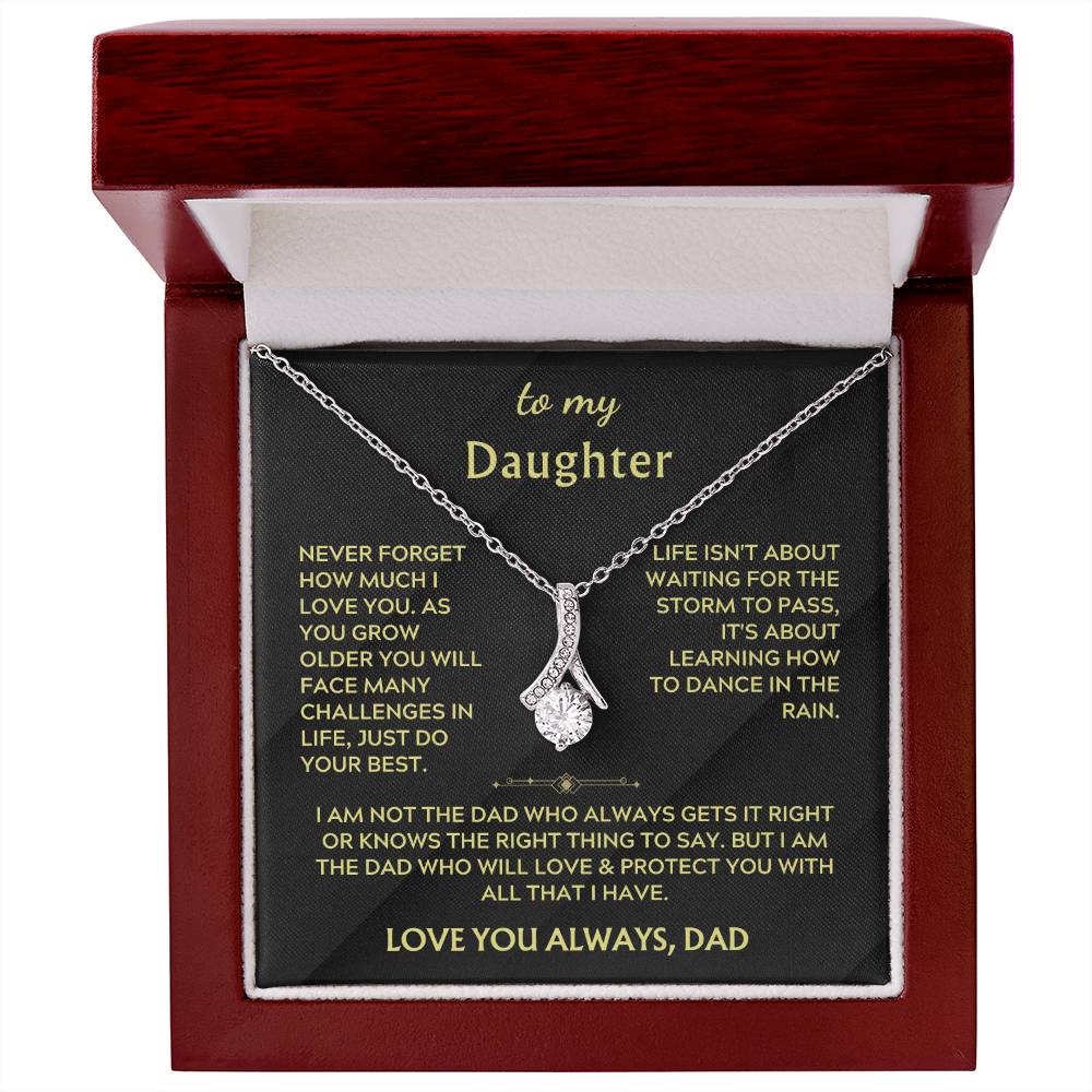 Red presentation box displaying a silver ribbon pendant necklace and daughter message