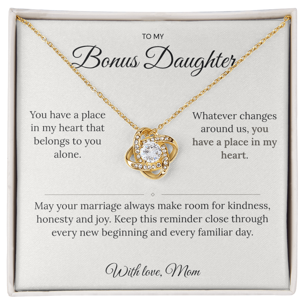 Gold Love Knot necklace displayed on a bonus daughter message card in a white box