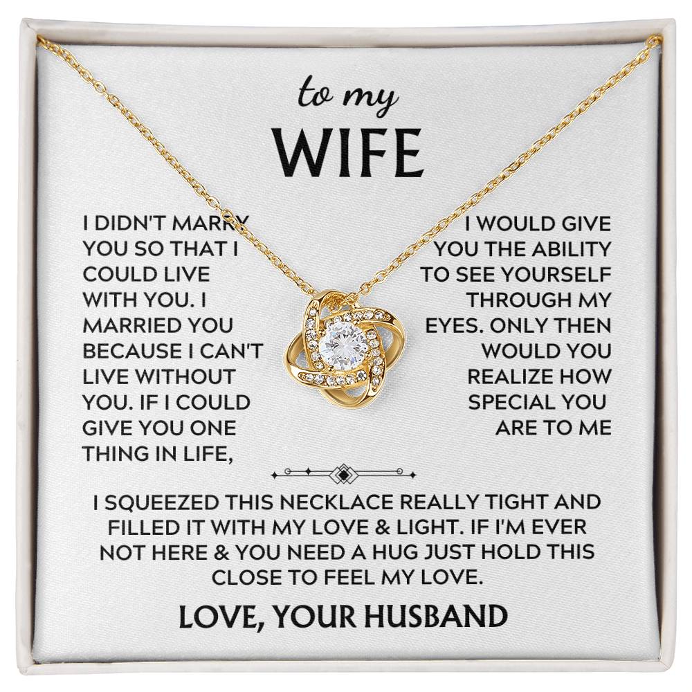 Gold Love Knot necklace displayed on a printed message card in a white presentation box
