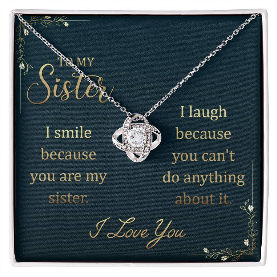 Silver-toned Love Knot Necklace displayed on a dark message card for a sister