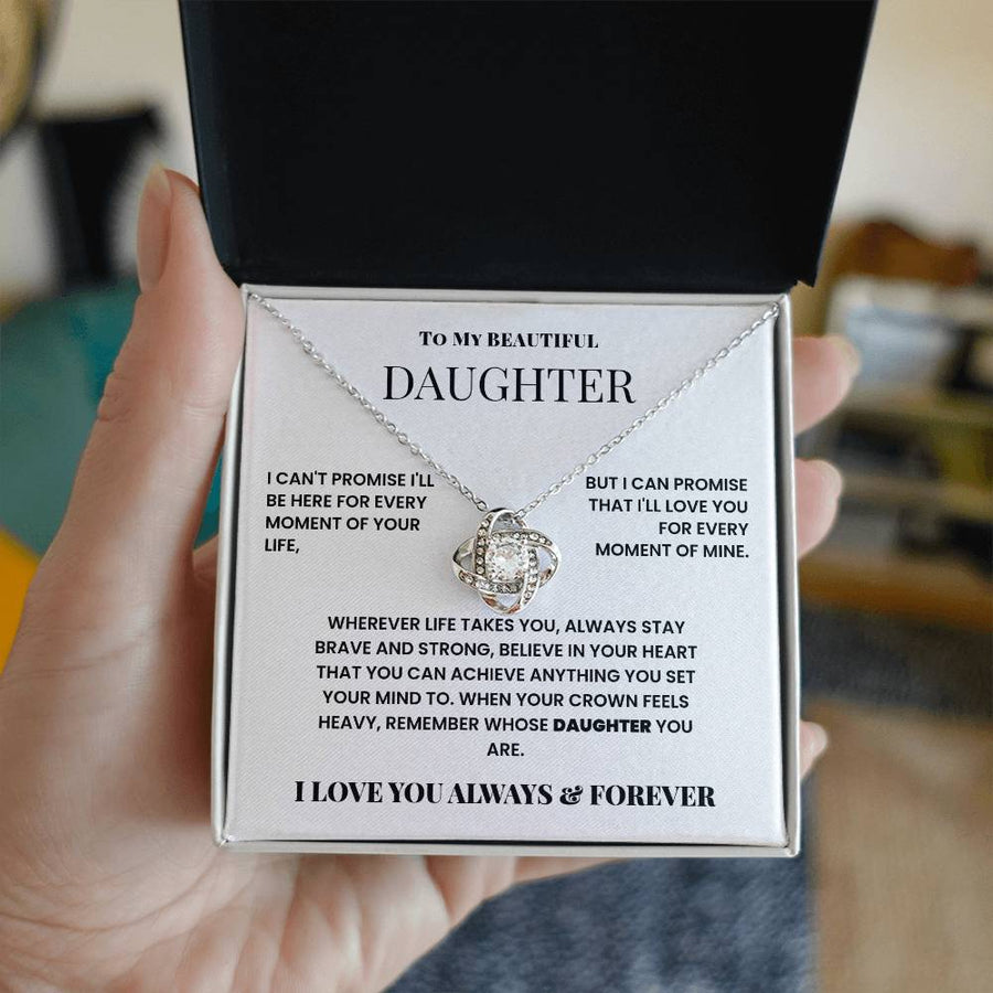 Hand-held open jewellery box showing a love knot necklace and daughter message card