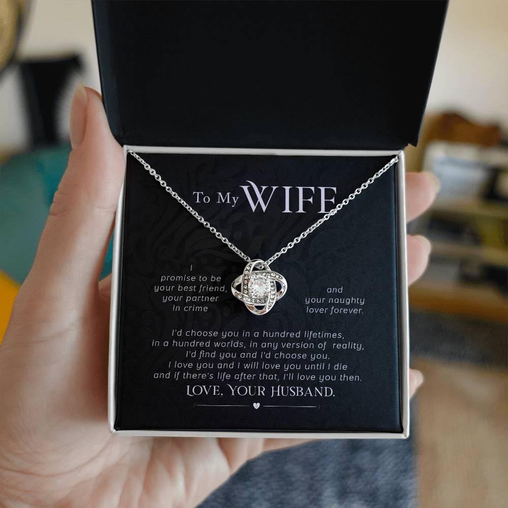Open jewellery box held in a hand, showing a Love Knot necklace and wife message card