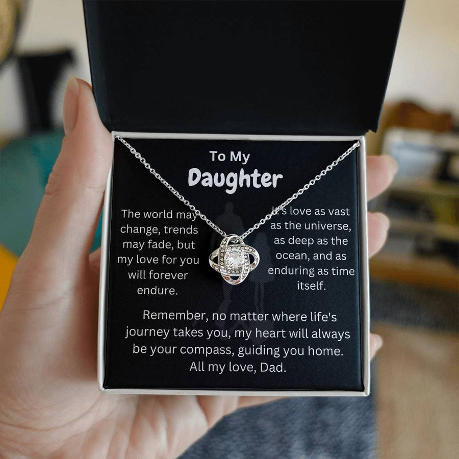 Silver love knot necklace displayed on a daughter message card inside an open black jewellery box