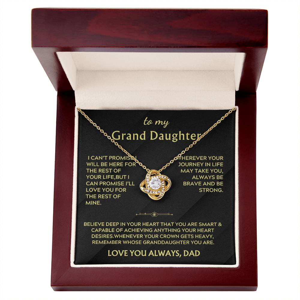 Gold Love Knot necklace and message card inside an open mahogany box
