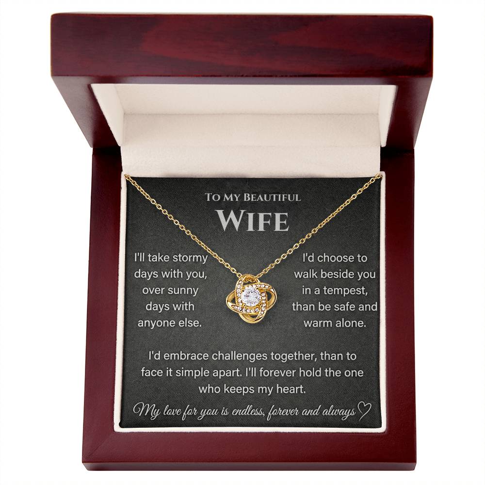 Gold Love Knot Necklace presented in an open mahogany-style box