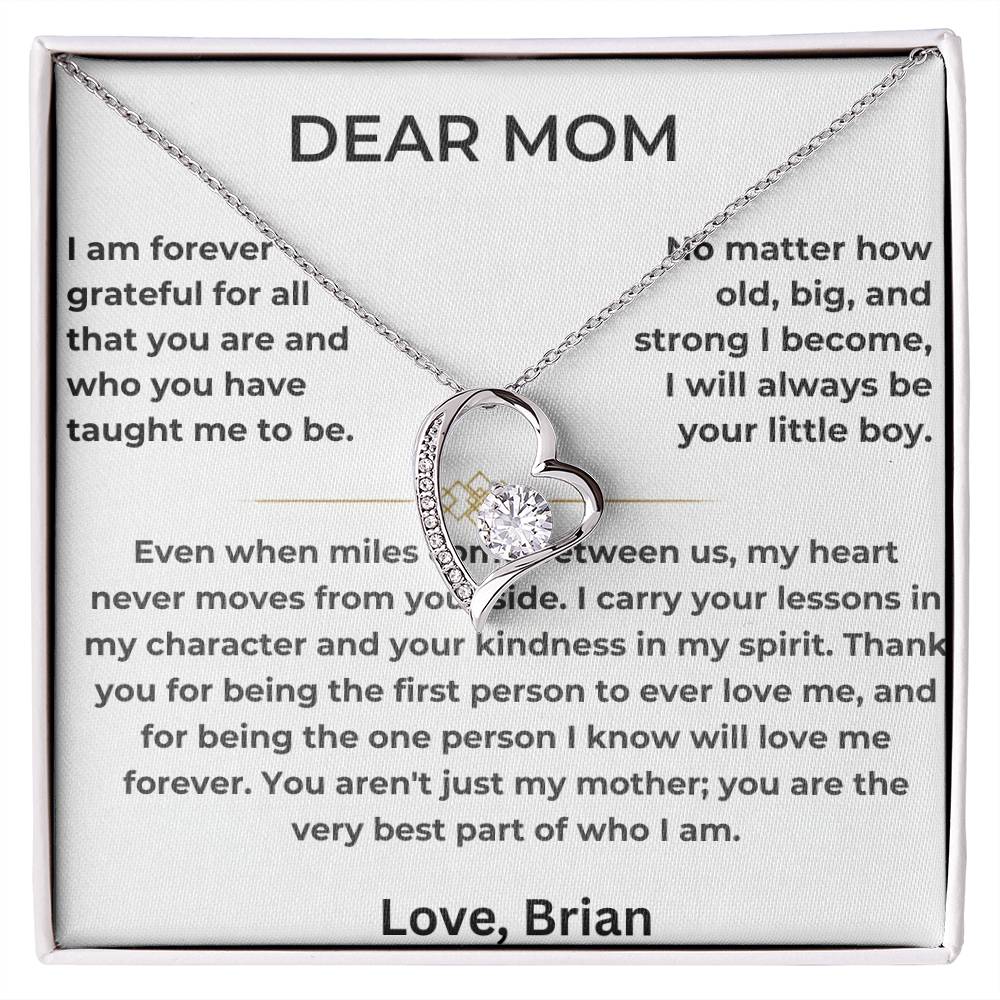 Silver heart pendant necklace displayed on a printed Dear Mom message card in a white box