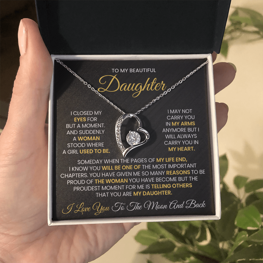 Silver heart necklace in an open presentation box with the daughter message card