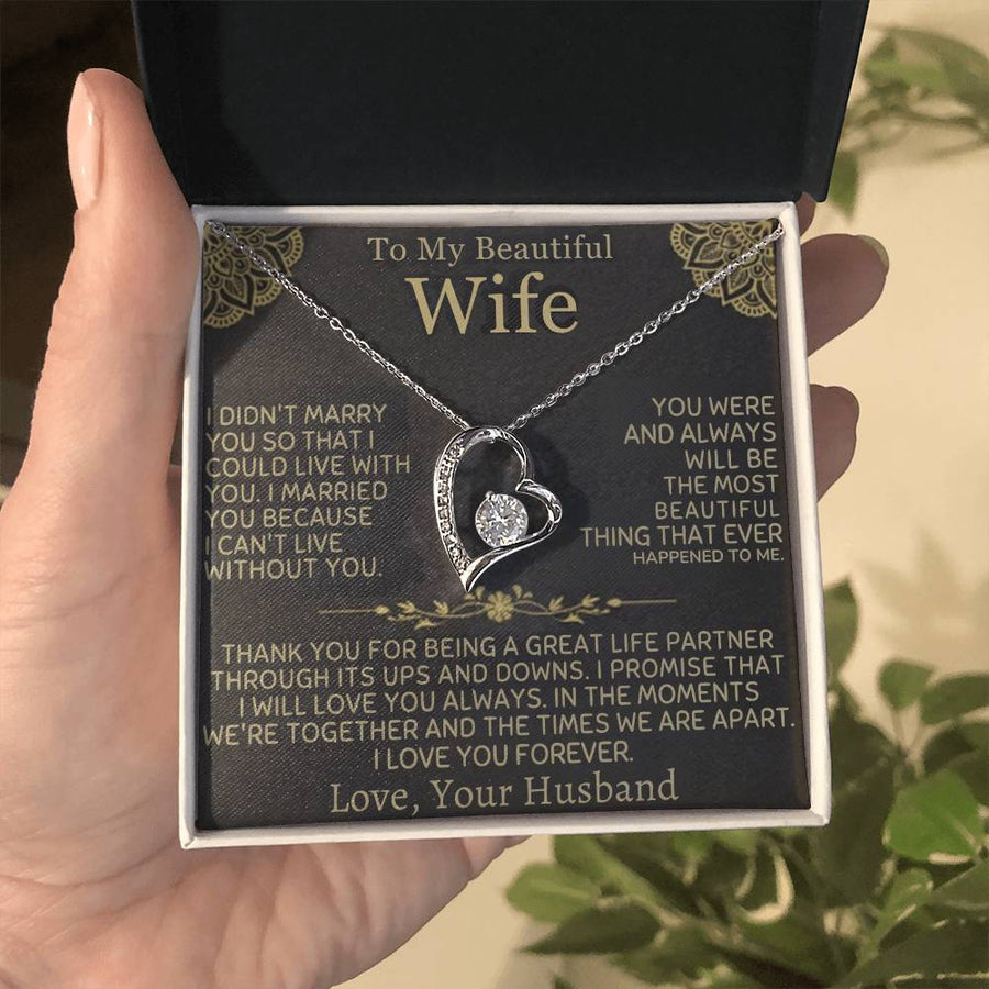 Silver-tone heart necklace on its message card, held in an open presentation box.