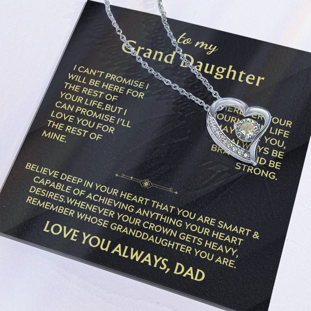 Close-up of a silver heart pendant and message card reading to my Grand Daughter