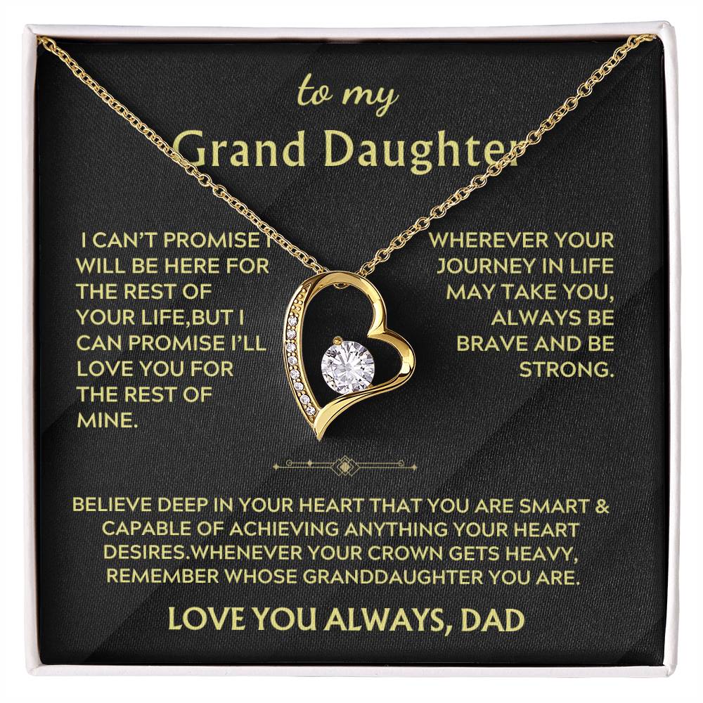 Gold heart-shaped necklace with a clear centre stone on a black Grand Daughter message card