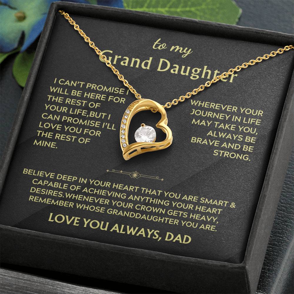 Gold heart pendant necklace in a black box with a Grand Daughter message card and flowers