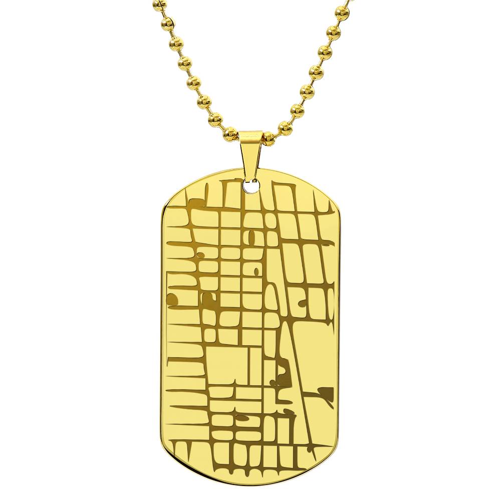 Gold-tone map dog tag necklace displayed against a plain white background
